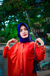 Portrait of young woman standing outdoors