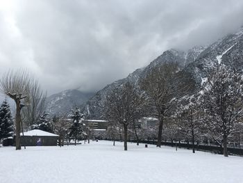 Scenic view of snow covered mountains against sky