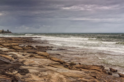 Scenic view of sea against cloudy sky