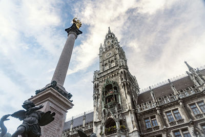 Low angle view of statue of building against cloudy sky