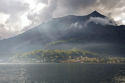 Close-up of lake como in a cloudy day with sunshine in bellagio, a tiny village in the italian alps.
