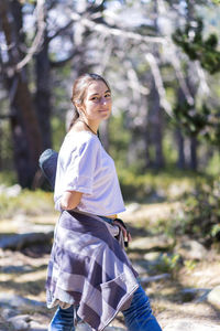 Portrait of smiling young woman standing outdoors