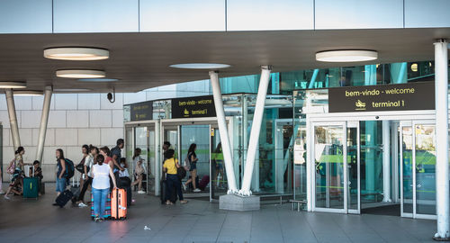 Group of people walking on illuminated railroad station platform