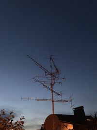 Low angle view of communications tower against sky