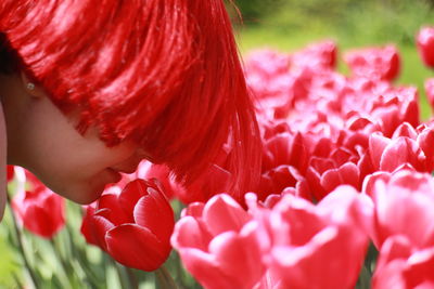 Close-up of woman with red flower