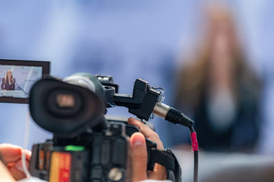 Rear view of man holding camera
