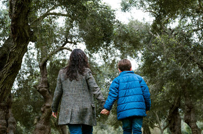 Rear view of women walking in forest