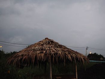 Panoramic view of hut on field against sky