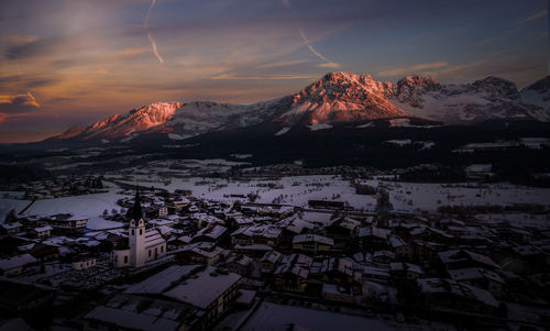 Scenic view of snowcapped mountains against sky during sunset