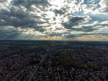 Aerial view of city against sky during sunset