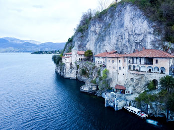 Drone view at the monastery of santa caterina del sasso on lake maggiore italy