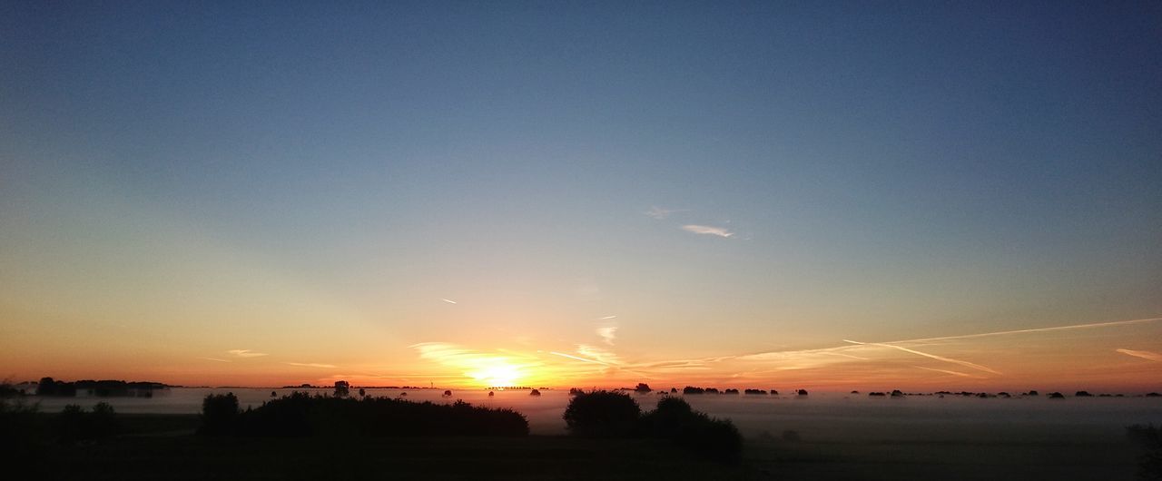 SILHOUETTE OF LANDSCAPE AT SUNSET