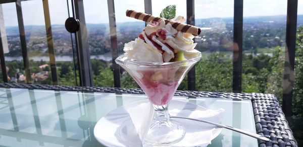 Close-up of ice cream on glass table