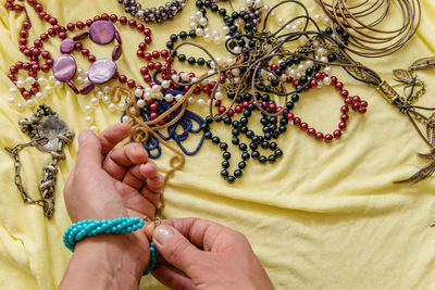 Cropped hands of woman wearing bracelet indoors