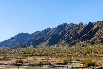 Scenic view of mountains against clear blue sky