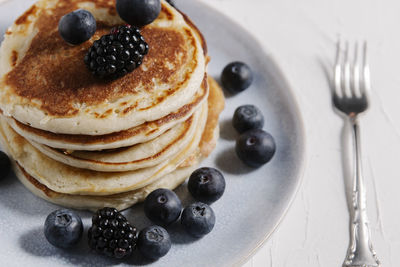 Stack of pancakes with berries on top