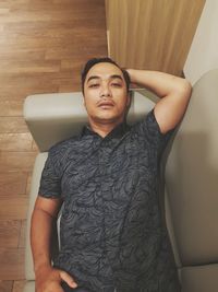 Young man lying on floor at home