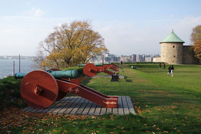 Park on field against sky in city