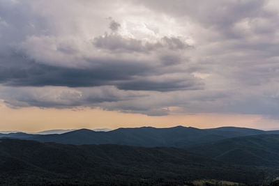 Scenic view of mountains against dramatic sky