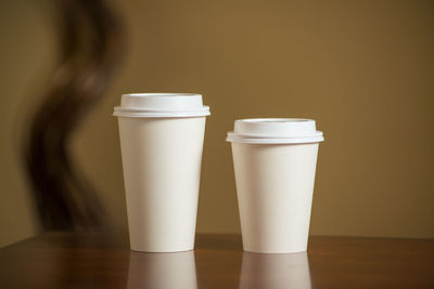 Close-up of disposable cups on table