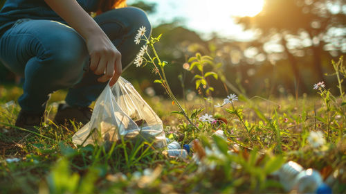 Low section of woman sitting on field