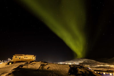 Low angle view of illuminated mountain against sky at night