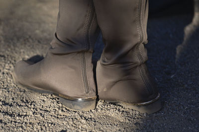 Low section of woman wearing shoes standing outdoors