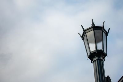 An old fashioned black metal lamp post on a clear blue sky in suburban pennsylvania