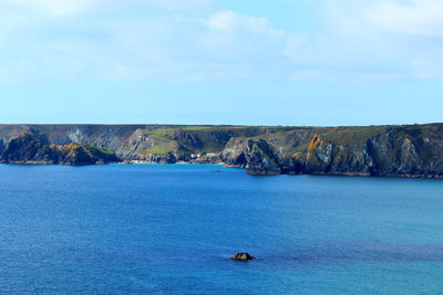 Beautiful coastline with a small fishermen village under the cliff .