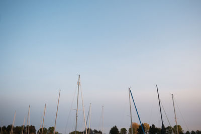 Low angle view of electricity pylon against clear sky