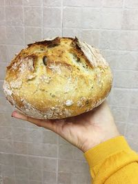 Close-up of woman holding loaf of bread