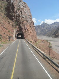 Road amidst mountains against sky