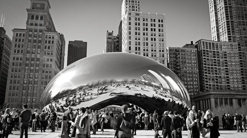 Low angle view of cloud gate in front of skyscrapers, at millennium park, in chicago. 2017.