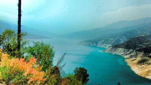 High angle view of landscape and sea against sky