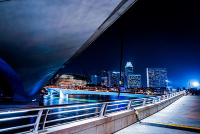 Illuminated bridge against sky at night
