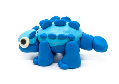 Close-up of blue toy against white background