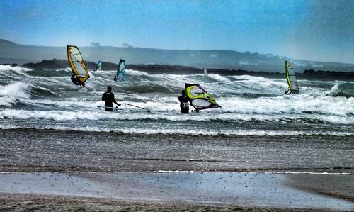 People surfing on beach