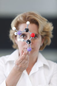 Scientist holding plastic molecular structure