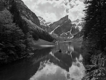 Scenic view of lake and mountains against sky