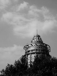 Low angle view of building against cloudy sky