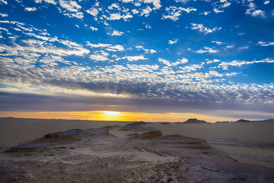 Scenic view of beach against sky during sunset