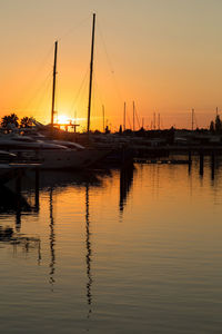 Sailboats in marina at sunset