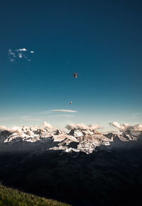 Scenic view of snowcapped mountains against blue sky