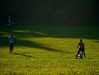 Rear view of man and woman on field