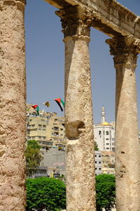 Low angle view of roman columns against sky