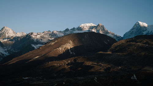 Scenic view of snowcapped mountains against clear sky