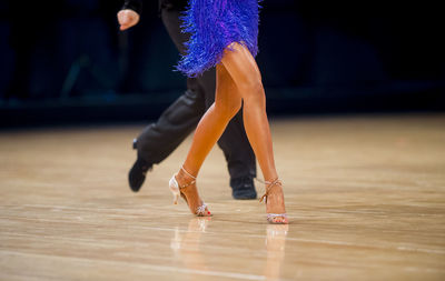 Low section of couple dancing on floor