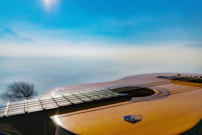Close-up of guitar against sky