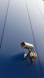 Close-up of coin-operated binoculars against sky