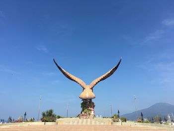 View of giraffe on field against sky